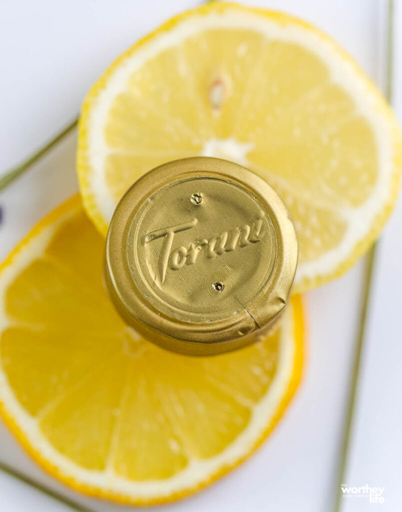 a gold cap with the word Torani stamped on it