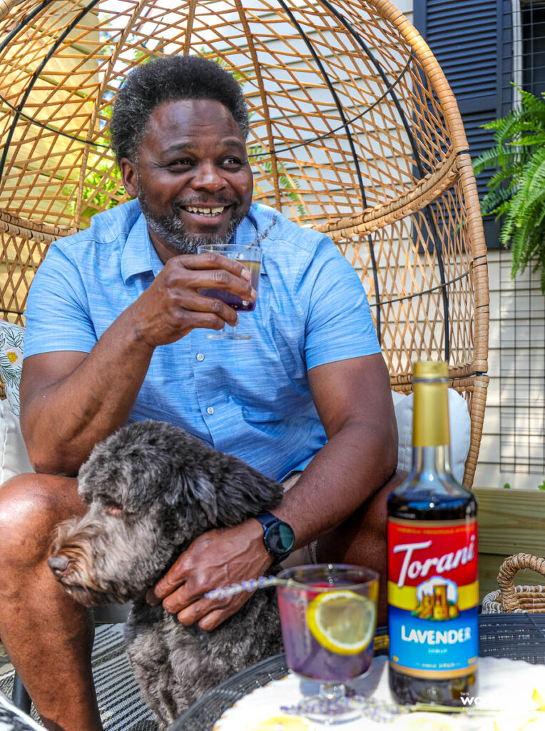 a man with his god and drinking a cocktail