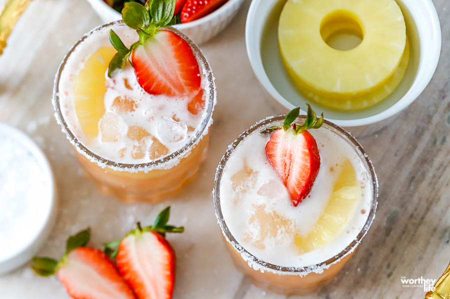 shrub cocktails in two glasses on a gold tray