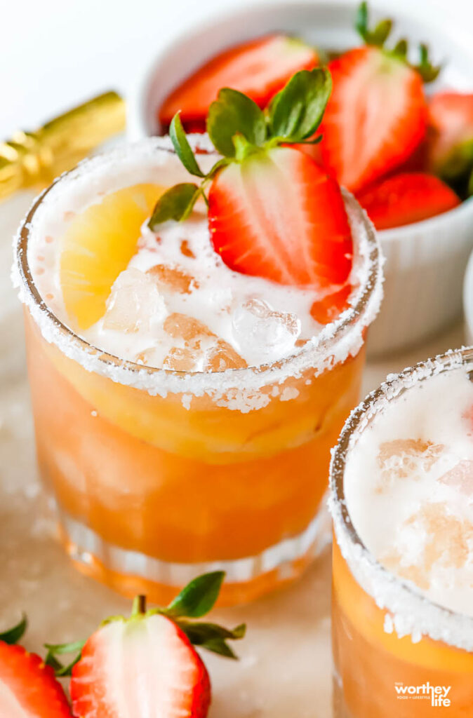 a frosted glass filled with strawberry shrub infused pineapple cocktail