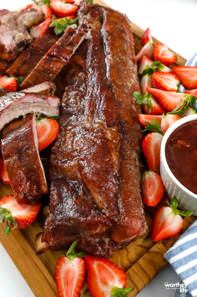 a slab of sticky strawberry baby back ribs and sauce