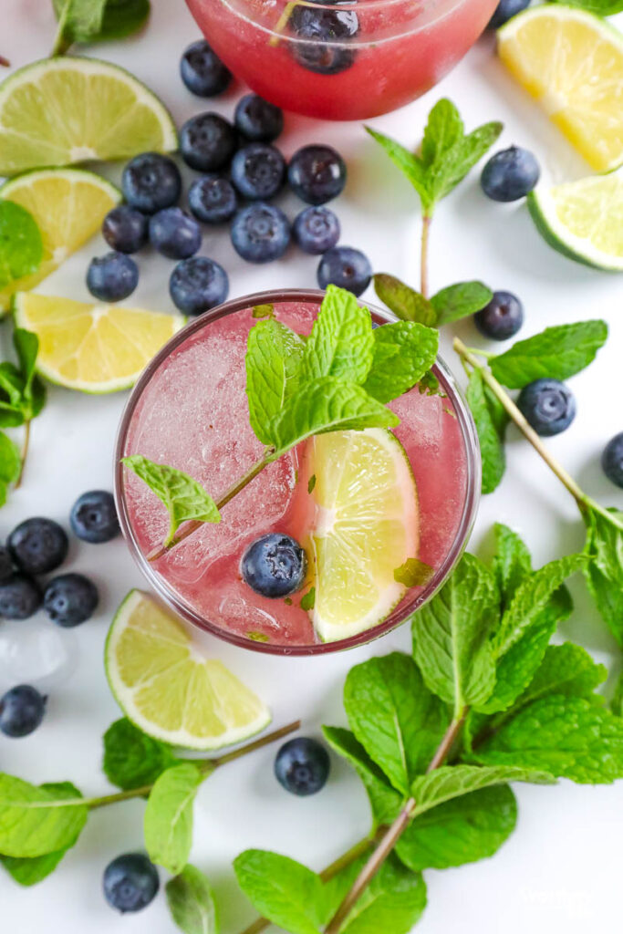 fresh fruit around a blueberry drink