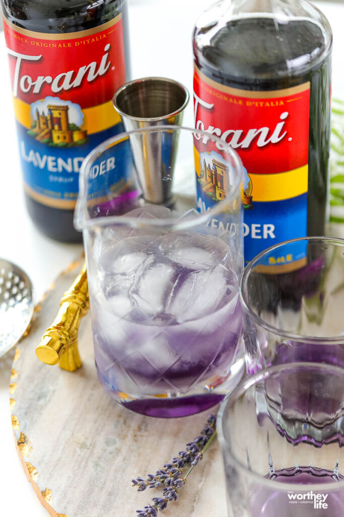 a cocktail mixing glass filled with ice