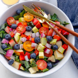 a colorful chopped summer salad served in white bowl