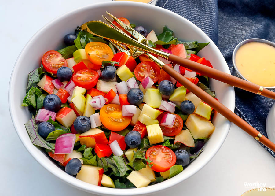 a bright colorful summer chopped garden salad in a white salad bowl