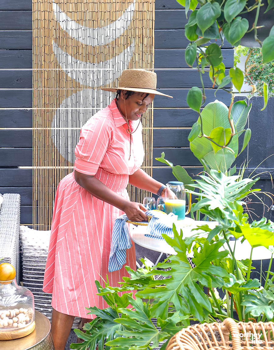 woman picking up a tray with orange juice on it