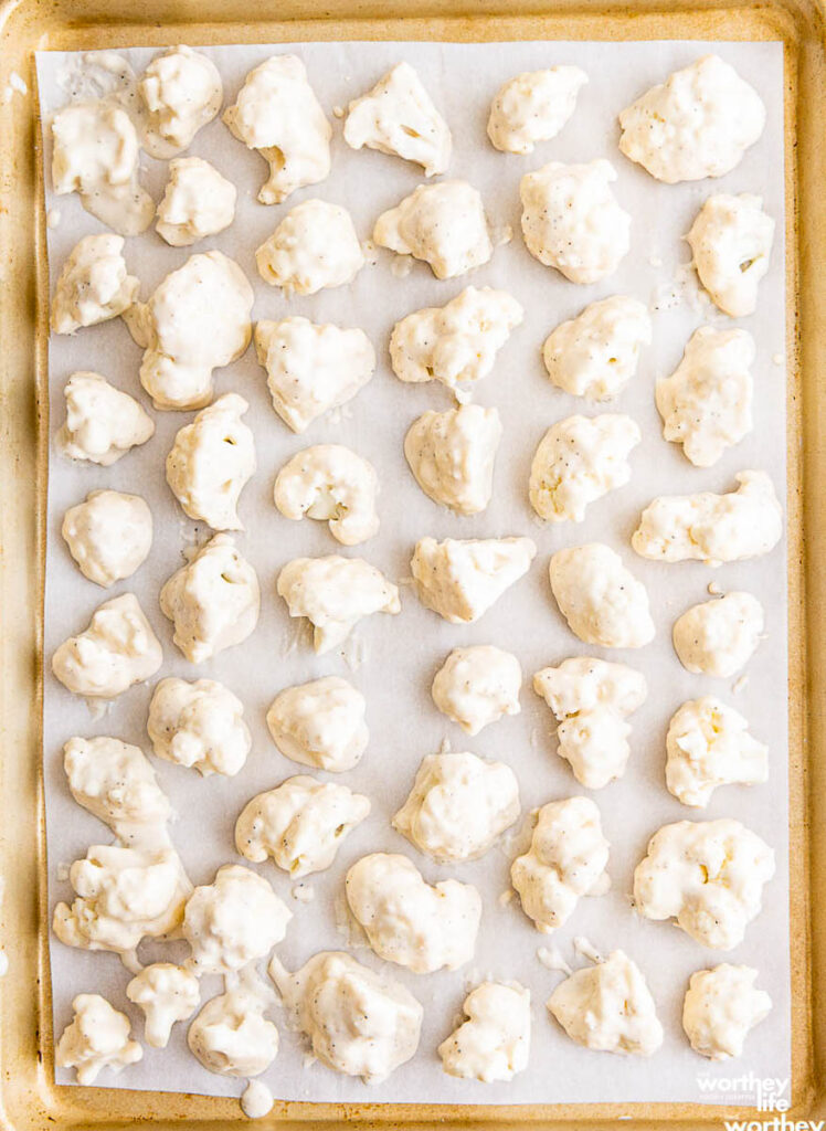 uncooked cauliflower on a sheet pan