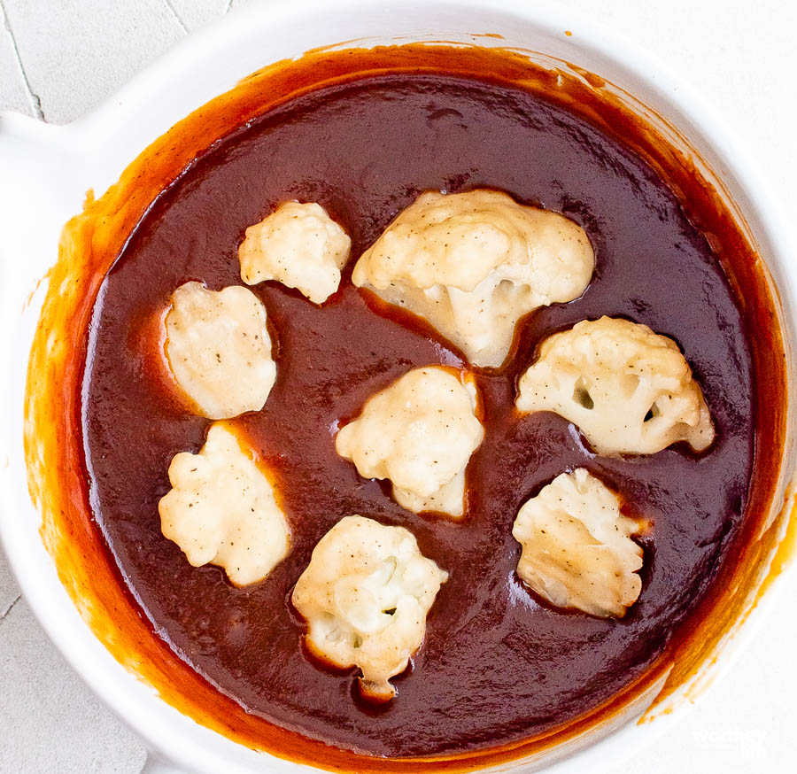 cauliflower in bbq sauce in a white bowl