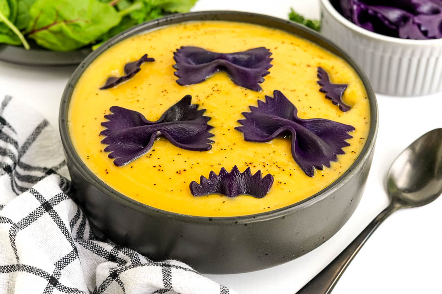 fall soup in a black bowl with spoon