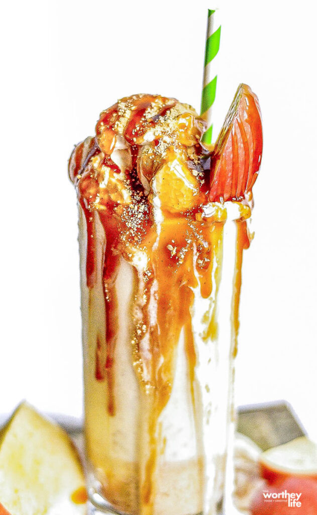 tall clear glass with caramel sauce and milkshake