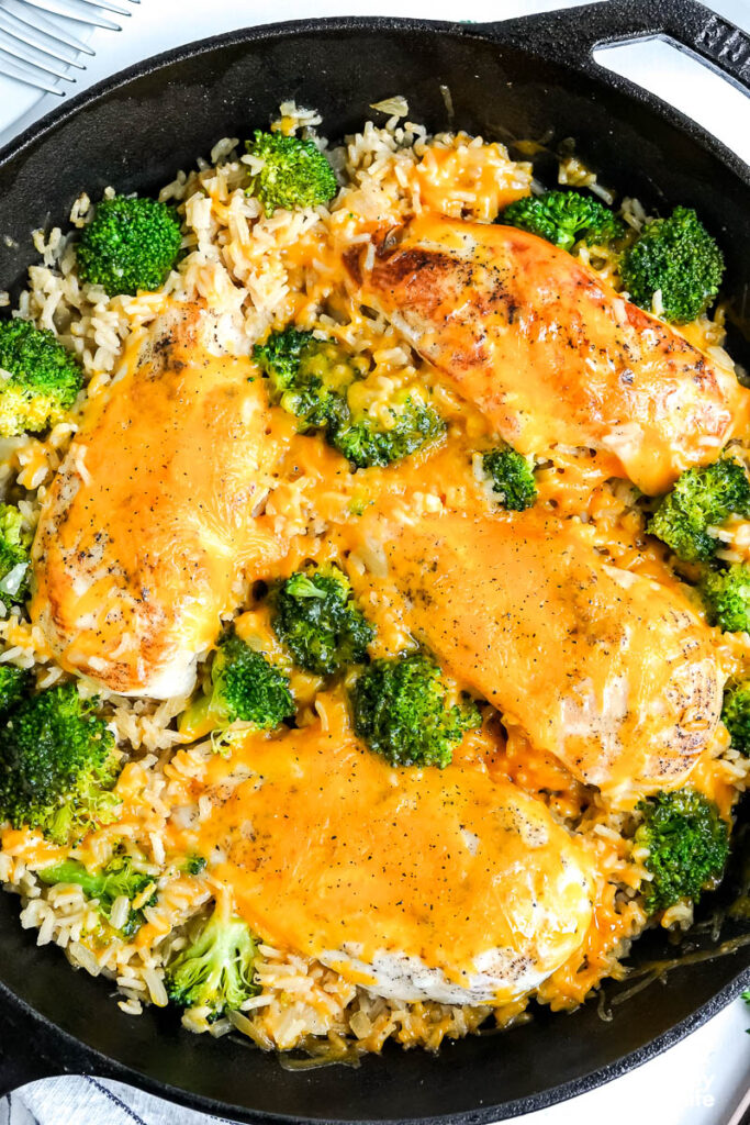 cheesy chicken in cast iron skillet with rice
