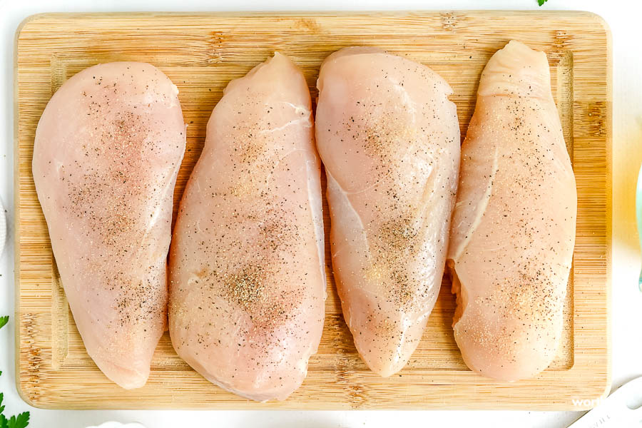 cutting chicken on cutting board