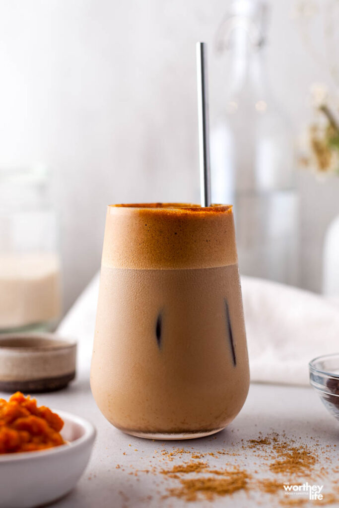 pumpkin coffee drink in glass with white background