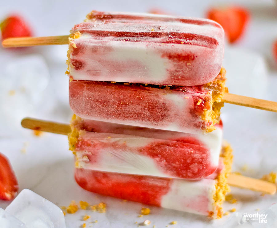 frozen strawberry popsicles stacked on top of each other