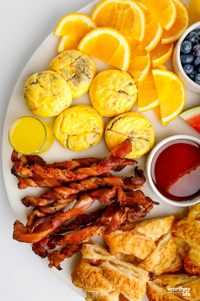 a white platter filled with an assortment of breakfast foods