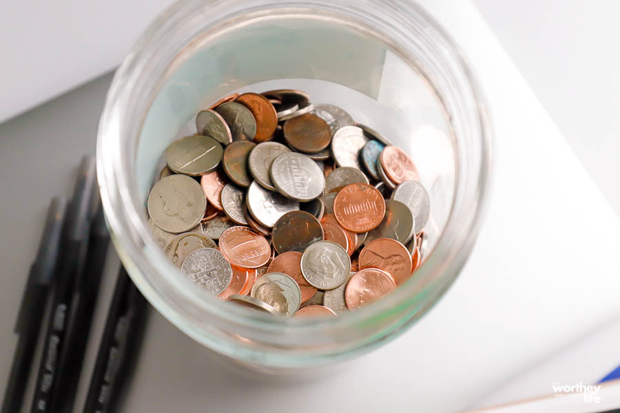 loose coins in a glass jar