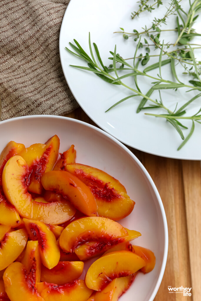 Fresh peaches and fresh herbs on white plates