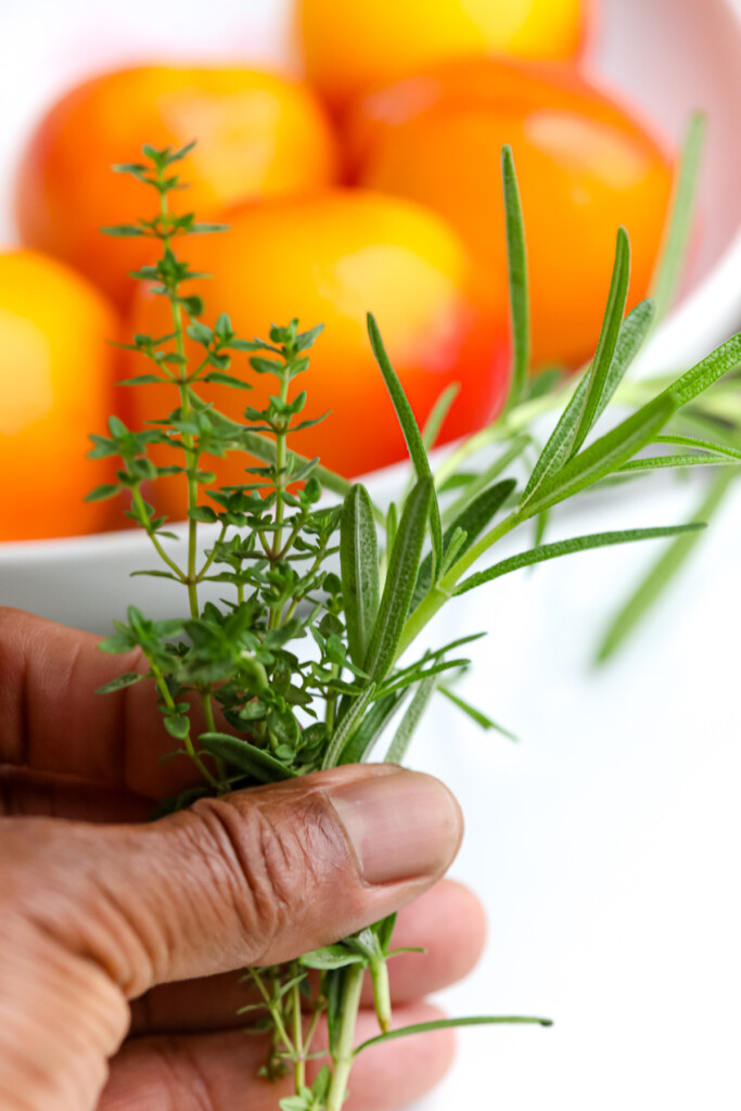 A man holding fresh herbs in his hand