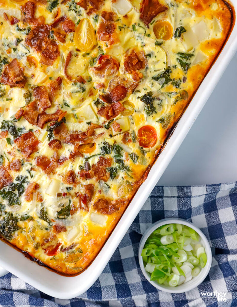 a colorful quiche in a white baking dish