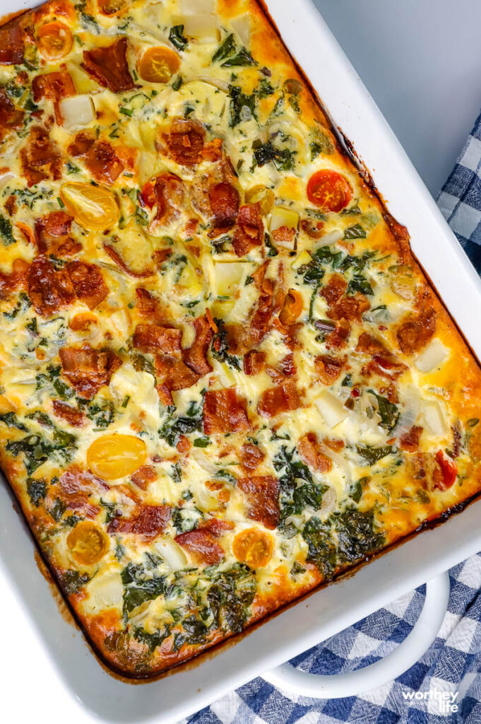 quiche with a crust baked in a white baking dish