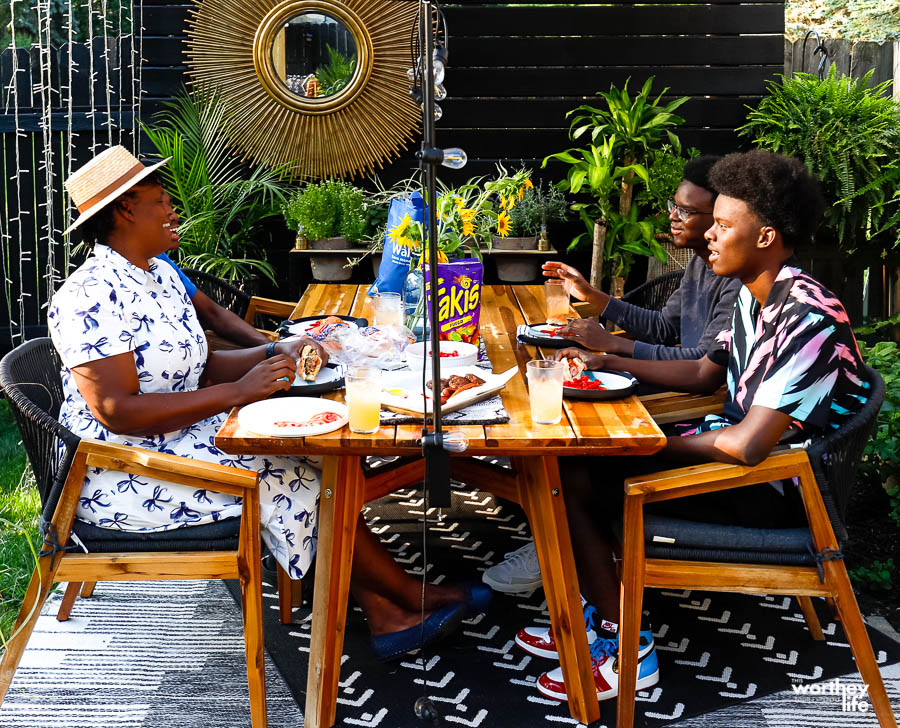 black family enjoying dining outdoors at their home