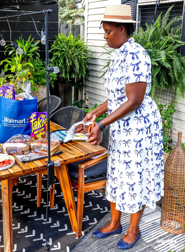 woman prepping table for outdoor family dinner night