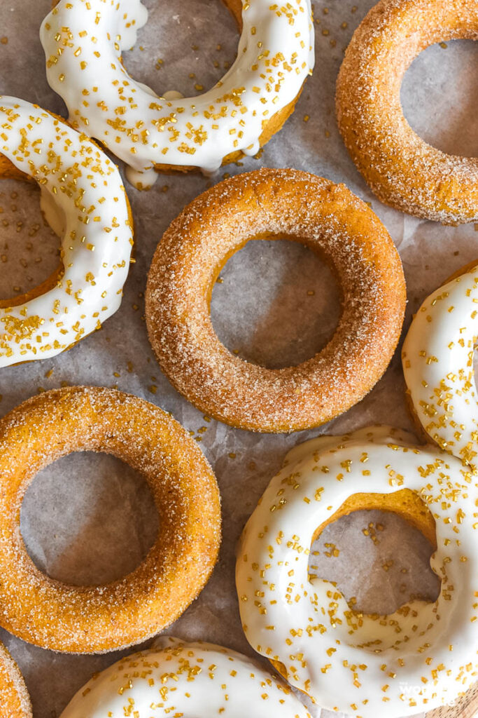 pumpkin doughnuts on a baking sheet