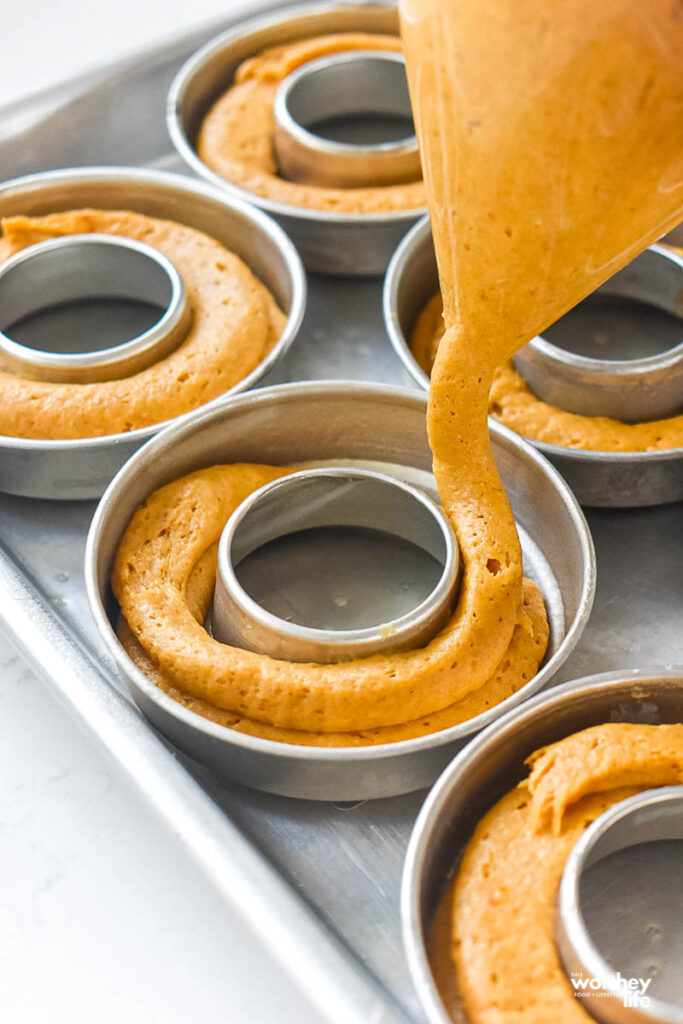 pouring pumpkin ingredients into donut pan