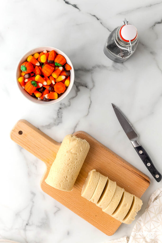 slicing cookie dough on cutting board