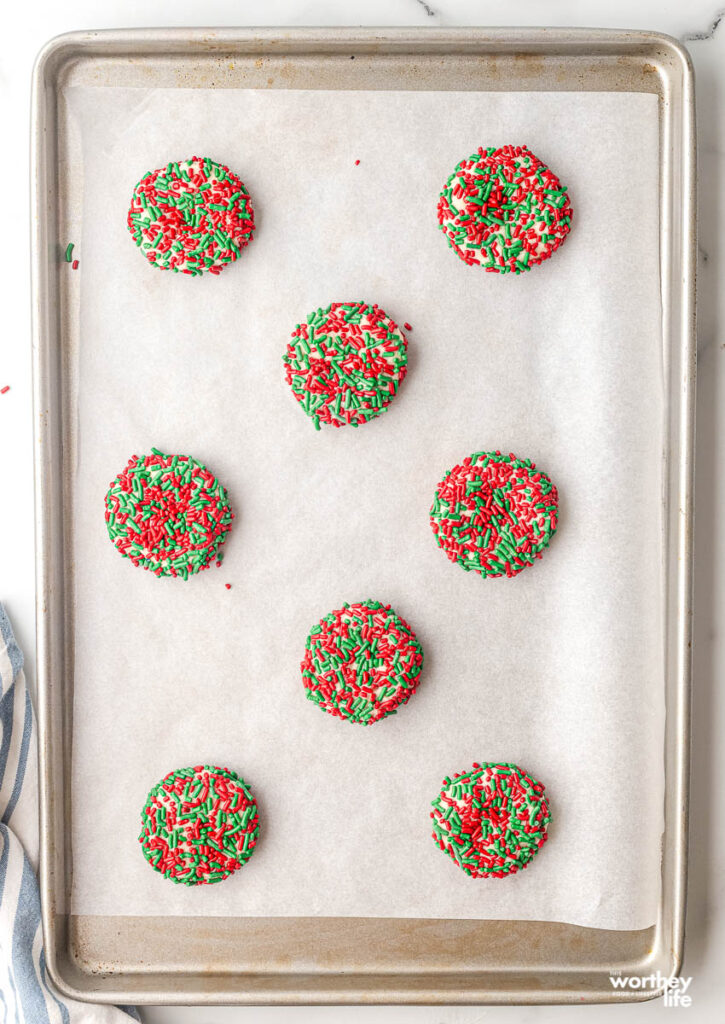 christmas sprinkle cookies on a baking sheet