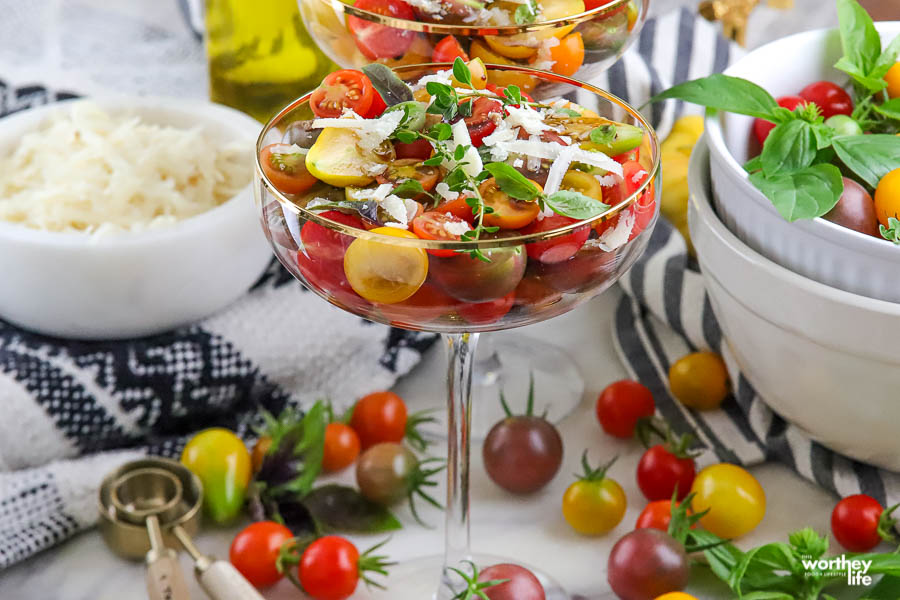 a gold-rimmed glass coupe filled with a beautiful tomato salad