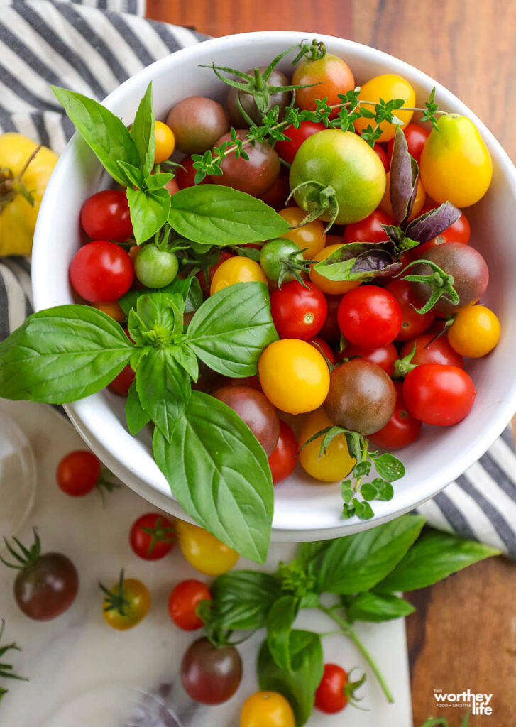a large white bowl filled with colorful tomatoes