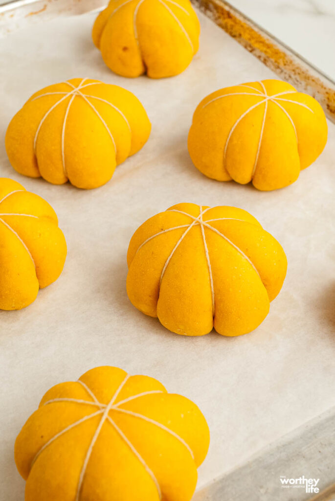 pumpkin rolls on baking sheet with twine