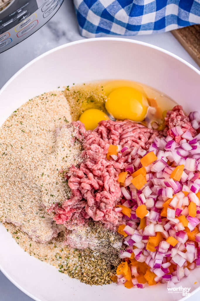 <span style='background-color:none;'>meatloaf ingredients</span><span style='background-color:none;'> </span>together in a white bowl” width=”683″ height=”1024″></p>
<h2>Ingredients You Will Need </h2>
<p><strong>Ground Beef</strong>. I used lean ground beef for this meatloaf recipe. Now, feel free to swap with ground turkey or even pork to alter the meatloaf. </p>
<p><strong>Milk. </strong>Whole, 2%, or even reach for dairy-free milk if you need to. </p>
<p><strong>Egg</strong>. The binder brings all the ingredients together and holds the shape as it bakes. </p>
<p><strong>Breadcrumbs</strong>. Italian breadcrumbs help to soak up the liquid and mesh it all together. Plus, the Italian spices add a nice flavor to the meatloaf. </p>
<p><strong>Onion</strong>. white or yellow work best for this recipe. </p>
<p><strong>Spices</strong>. Garlic salt, pepper, and oregano. </p>
<p><strong>Potatoes.</strong> Mini potatoes, diced Yukon, or even Russets all make incredibly smooth and creamy mashed potatoes. </p>
<p><strong>Oil.</strong> Olive oil is my preferred oil.</p>
<p><img decoding=