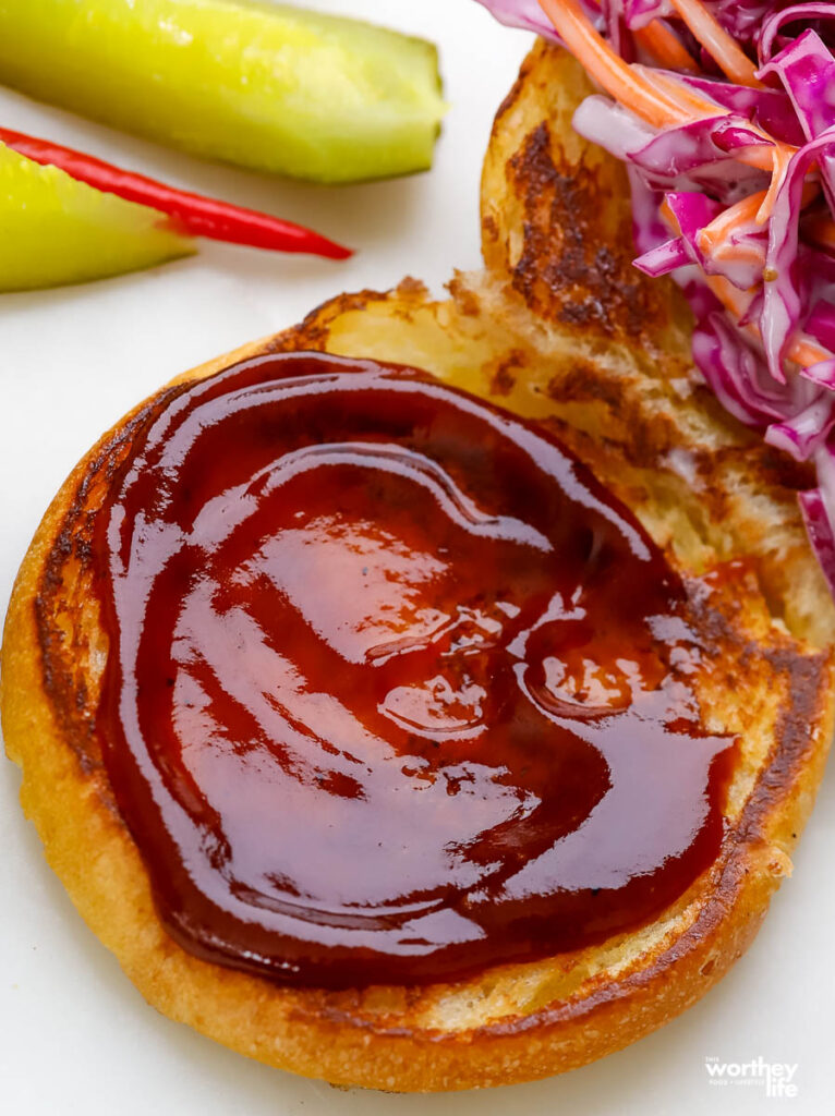 a toasted bun smeared with barbecue sauce