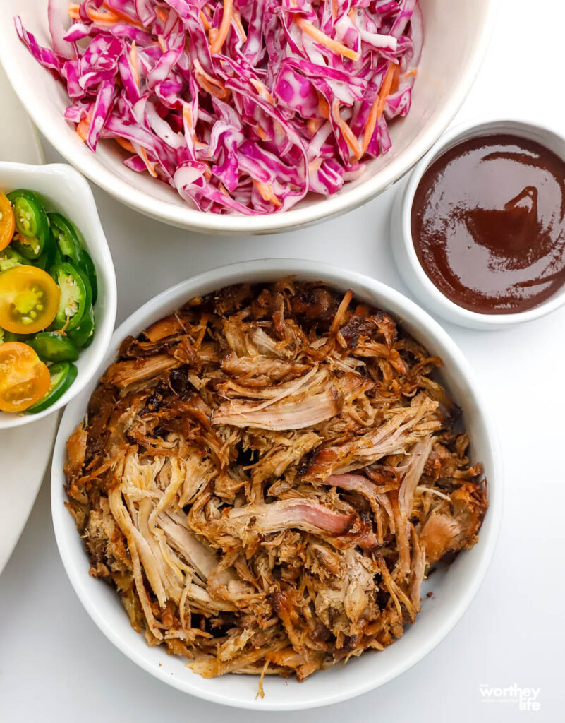 serving bowls with pork, coleslaw, and barbecue sauce