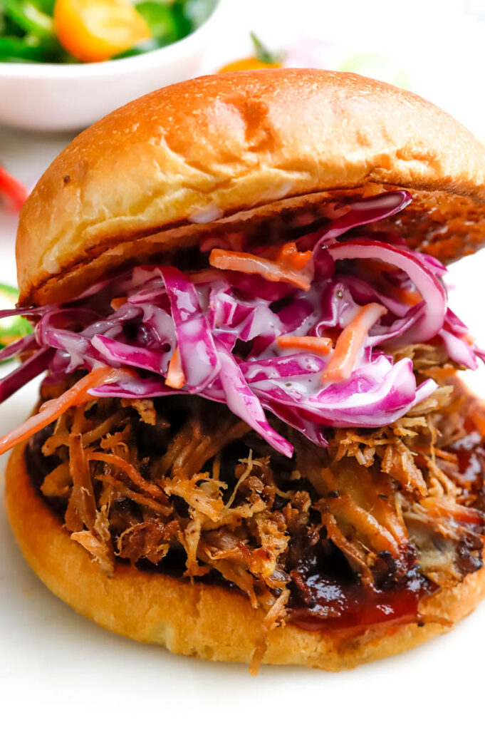 Pulled Pork sandwich with red cabbage coleslaw on a toasted bun