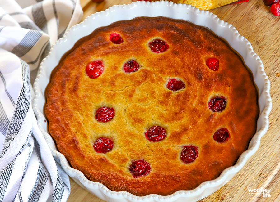 fresh poke cranberry cake in white baking dish