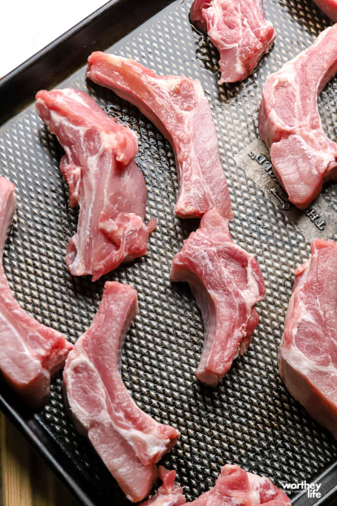 cuts of baby back ribs on baking sheet