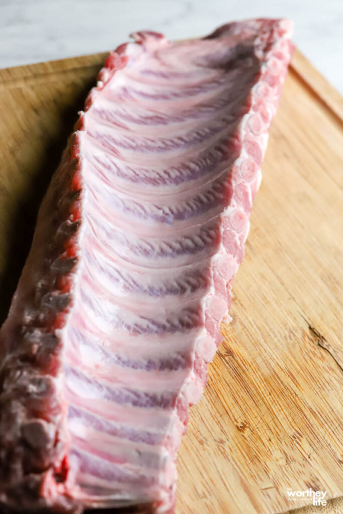 rack of baby back ribs on cutting board