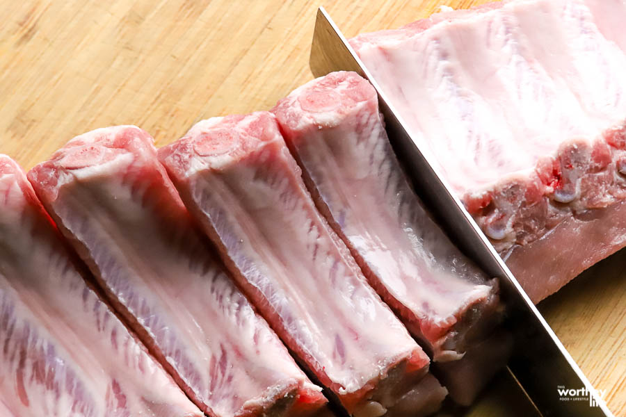 sharp chef knife cutting baby back ribs