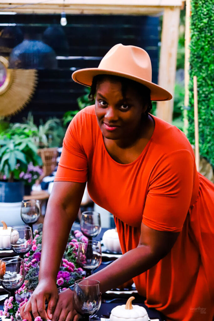 african american woman putting together a tablescape