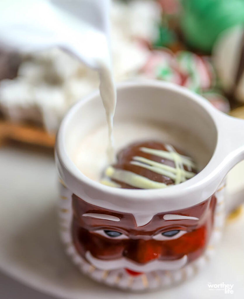 hot cocoa bomb in action in santa mug