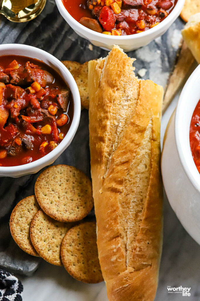 bowls of chili served with bread