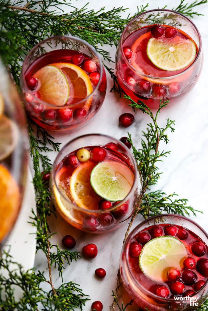 glasses of sprite with cranberry punch on white background