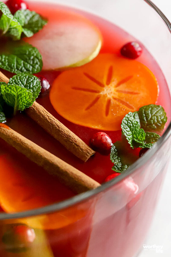 Festive punch bowl filled with pear and cranberry juice plus cranberry ginger ale soda