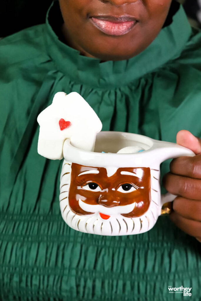 woman holding a santa christmas mug