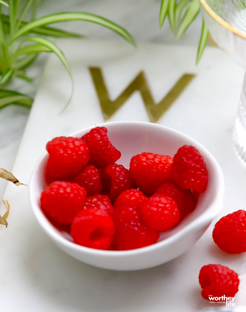 fresh raspberries in white bowl