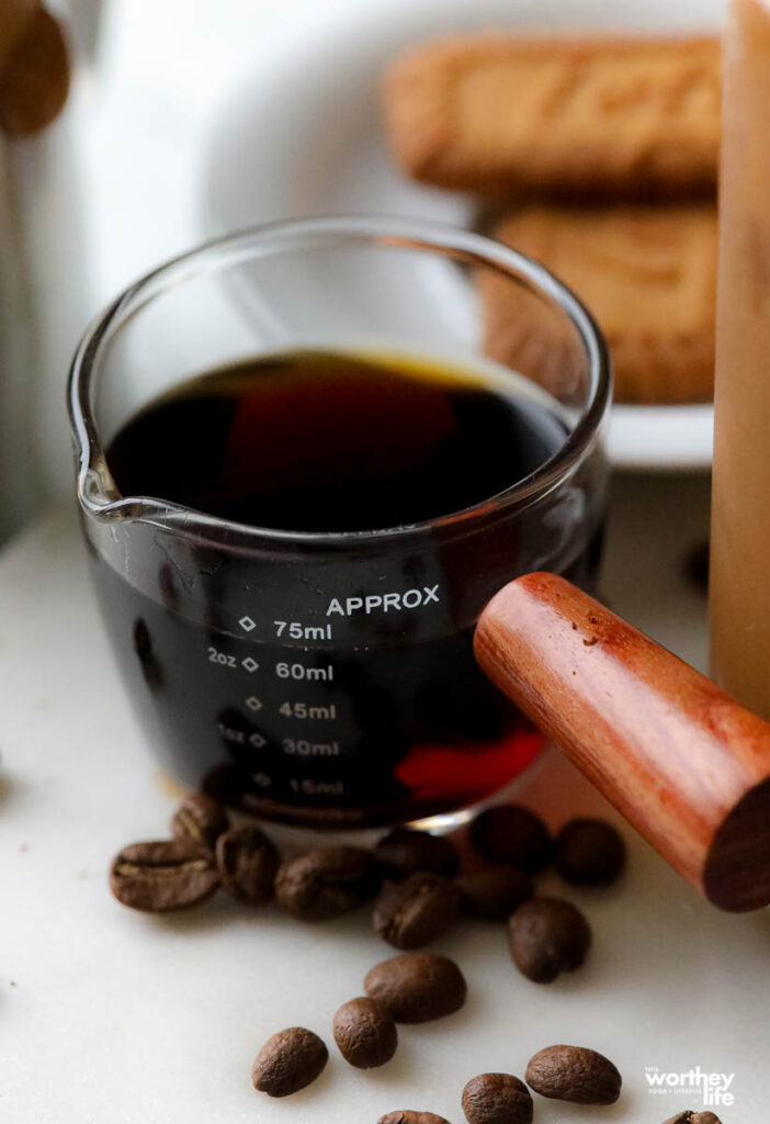 a measuring cup filled with brewed coffee