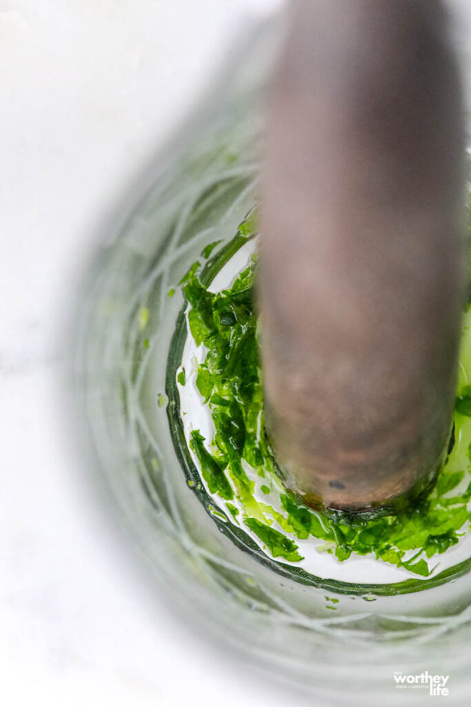 mudding mint in a glass jar